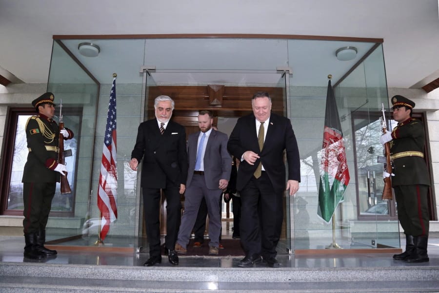 U.S. Secretary of State Mike Pompeo, center right, and Abdullah Abdullah the main political rival of President Ashraf Ghani, center left, walk at the Sepidar palace, in Kabul, Afghanistan, Monday, March 23, 2020. Pompeo was in Kabul on an urgent visit Monday to try to move forward a U.S. peace deal signed last month with the Taliban, a trip that comes despite the coronavirus pandemic, at a time when world leaders and statesmen are curtailing official travel.