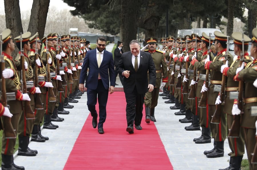 U.S. Secretary of State Mike Pompeo, right, and Afghanistan&#039;s National Security Adviser Hamdullah Mohib, arrives at the Presidential Palace in Kabul, Afghanistan, Monday, March 23, 2020. Pompeo was in Kabul on an urgent visit Monday to try to move forward a U.S. peace deal signed last month with the Taliban, a trip that comes despite the coronavirus pandemic, at a time when world leaders and statesmen are curtailing official travel.