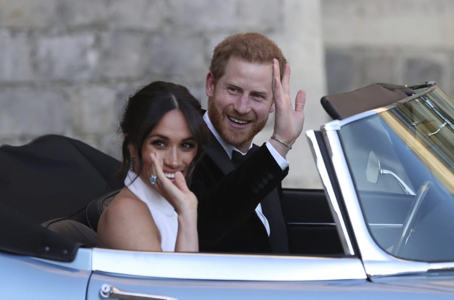 FILE - In this Saturday, May 19, 2018 file photo the newly married Duke and Duchess of Sussex, Meghan Markle and Prince Harry, leave Windsor Castle in a convertible car after their wedding in Windsor, England, to attend an evening reception at Frogmore House, hosted by the Prince of Wales. Prince Harry and his wife Meghan are ending their lives as senior members of Britain&#039;s royal family and starting an uncertain new chapter as international celebrities and charity patrons. In January the couple shocked Britain by announcing that they would step down from official duties, give up public funding, seek financial independence and swap the U.K. for North America. The split becomes official on March 31.