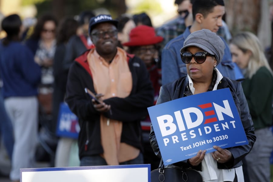 People wait to attend a campaign rally for Democratic presidential candidate former Vice President Joe Biden on Tuesday, March 3, 2020, in Los Angeles.