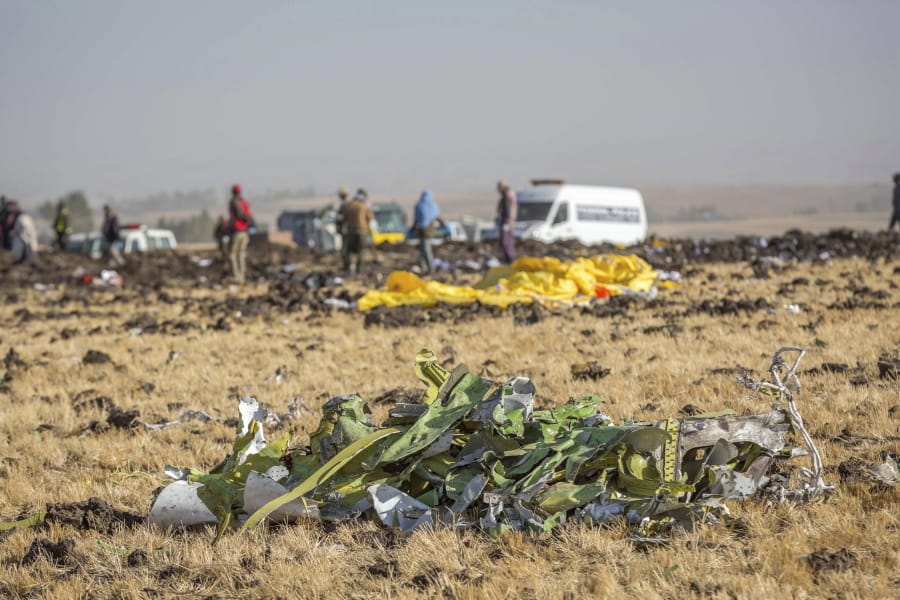 FILE - In this March 11, 2019 file photo, parts of the plane wreckage lie at the scene where the Ethiopian Airlines Boeing 737 Max 8 crashed shortly after takeoff on Sunday killing all 157 on board at the crash site at Bishoftu, or Debre Zeit, outside Addis Ababa, Ethiopia. When air safety investigators release an interim report on the crash of an Ethiopian Airlines Boeing 737 Max sometime before Tuesday, March 10, 2020, the one-year anniversary of the crash, they are likely to place the blame on the jet&#039;s automated flight control system as well as on the pilots and their training, but it&#039;s unclear yet which side will bear the brunt.