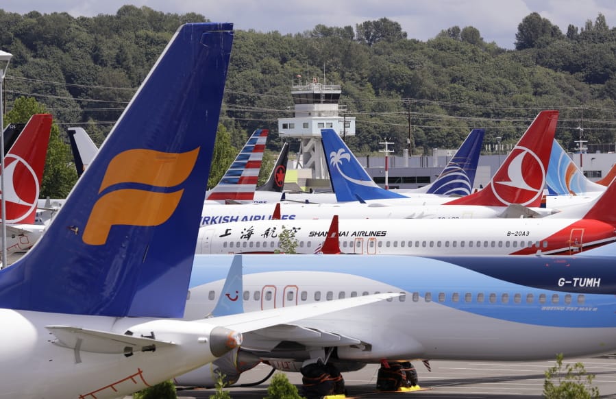 FILE - In this June 27, 2019 file photo, dozens of grounded Boeing 737 MAX airplanes crowd a parking area adjacent to Boeing Field in Seattle. When air safety investigators release an interim report on the crash of an Ethiopian Airlines Boeing 737 Max sometime before Tuesday, March 10, 2020, the one-year anniversary of the crash, they are likely to place the blame on the jet&#039;s automated flight control system as well as on the pilots and their training, but it&#039;s unclear yet which side will bear the brunt.