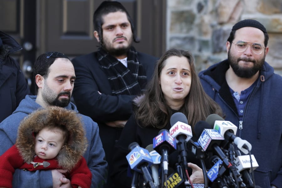 FILE - In this Jan. 2, 2020, file photo, surrounded primarily by family, Nicky Kohen, the daughter of Josef Neumann who was critically injured in an attack on a Hanukkah celebration, speaks to reporters in front of her home in New City, N.Y. An Orthodox Jewish organization said Neumann died Sunday, March 29, 2020, from his injuries three months after the attacks.