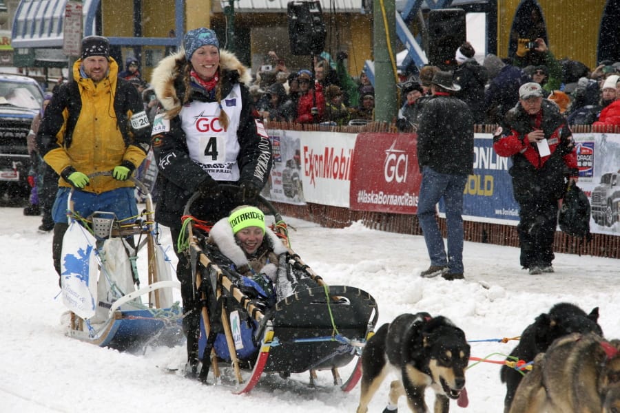 Musher Kristy Berington (bib No. 4) of Knik, Alaska, leaves the start line before the ceremonial start of the Iditarod Trail Sled Dog Race Saturday, March 7, 2020, in Anchorage, Alaska. The real race starts March 8 about 50 miles north of Anchorage, with the winner expected in the Bering Sea coastal town of Nome about 10 or 11 days later.