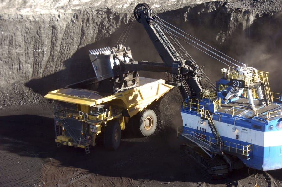 A mechanized shovel loads coal from an 80-foot-thick seam in November 2016 at the Spring Creek mine near Decker, Mont.