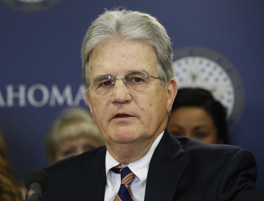 FILE - In this March 28, 2018 file photo, former U.S. Sen. Tom Coburn speaks at a news conference in Oklahoma City.  Coburn has died. He was 72. A cousin tells The Associated Press that he died early Saturday, March 28, 2020. Coburn had been diagnosed with prostate cancer years earlier. The Oklahoma Republican railed against federal earmarking and earned a reputation as a political maverick.