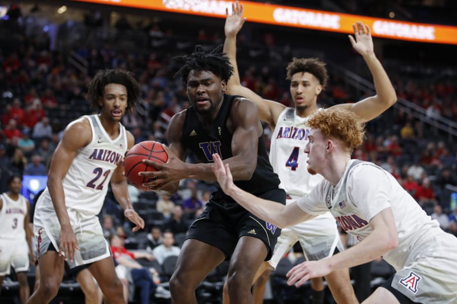 Washington&#039;s Isaiah Stewart (33) grabs a rebound over Arizona&#039;s Nico Mannion, right, during the first half of an NCAA college basketball game in the first round of the Pac-12 men&#039;s tournament Wednesday, March 11, 2020, in Las Vegas.
