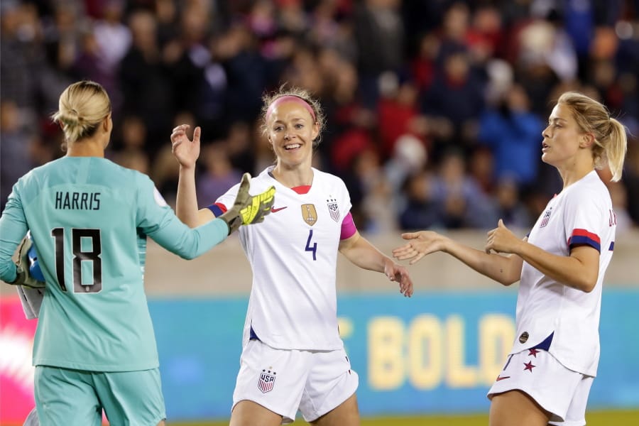 U.S. goalkeeper Ashlyn Harris (18), defender Becky Sauerbrunn (4) and defender Abby Dahlkemper, right, celebrate the team&#039;s 8-0 win over Panama in a CONCACAF women&#039;s Olympic qualifying soccer match Friday, Jan. 31, 2020, in Houston.