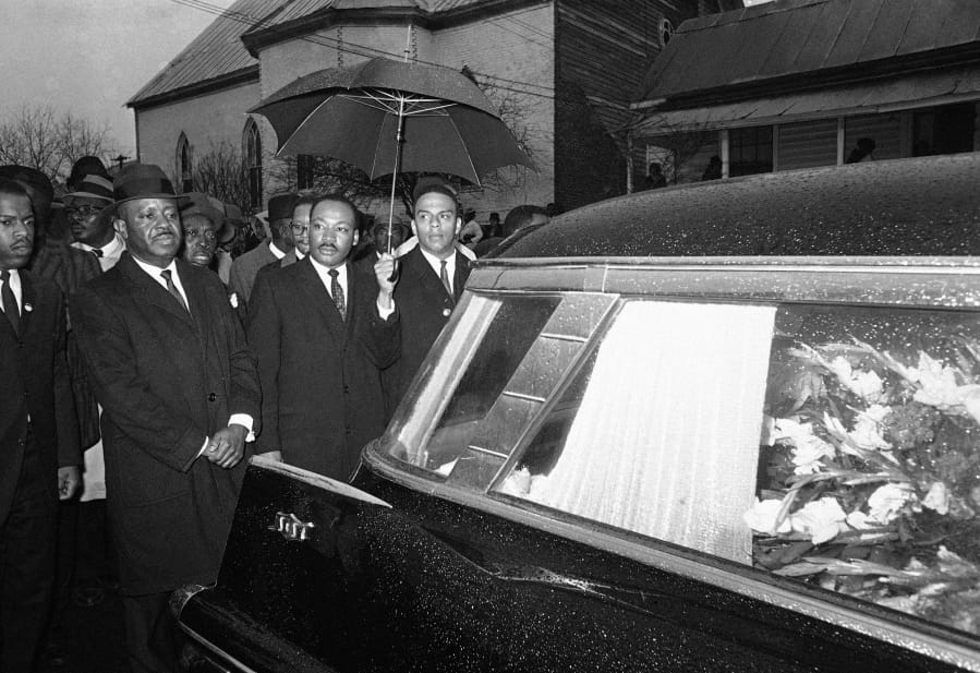 The Rev. Martin Luther King Jr. leads a procession behind the casket of Jimmie Lee Jackson during funeral rites March 1, 1965, at Marion, Ala. From left, John Lewis, the Rev. Ralph Abernathy, King and the Rev. Andrew Young.