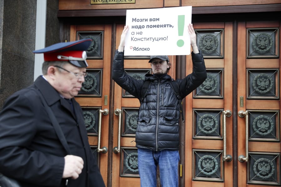 A member of the liberal Yabloko Party holds a poster reading: &quot;You need to change the brain, not the constitution!&quot; as he stages a one-man picket at the State Duma, the Lower House of the Russian Parliament in Moscow, Russia, Wednesday, March 11, 2020. The Russian parliament has approved a sweeping constitutional reform that will allow President Vladimir Putin to stay in power for another 12 years after his current term ends in 2024. Wednesday&#039;s vote was the third and final reading.