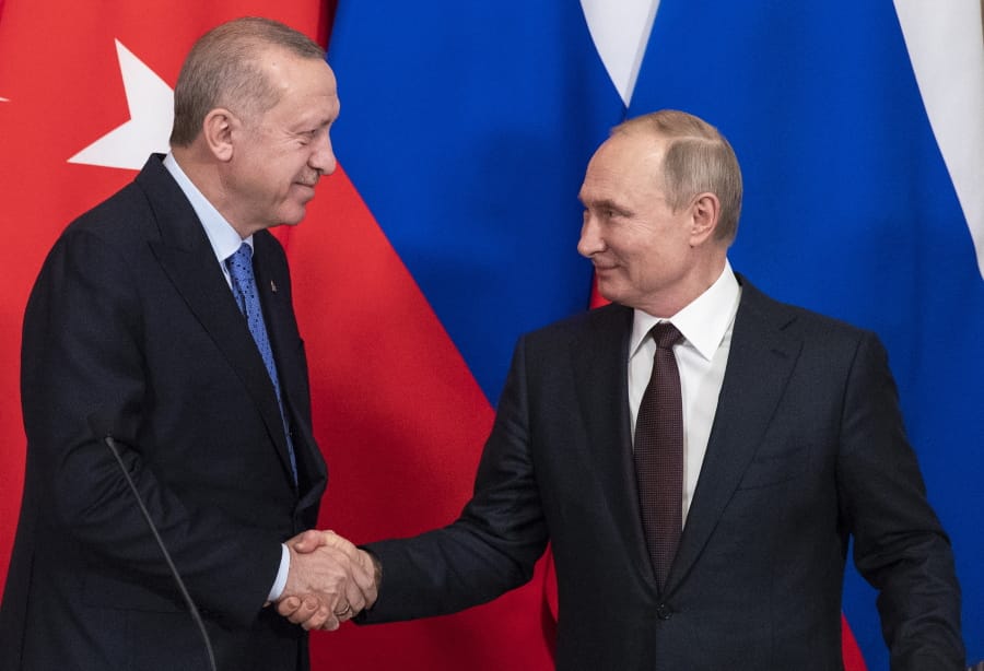 Russian President Vladimir Putin, right, and Turkish President Recep Tayyip Erdogan shake hands during a news conference after their talks in the Kremlin, in Moscow, Russia, Thursday, March 5, 2020. Russian President Vladimir Putin and his Turkish counterpart, Recep Tayyip Erdogan, say they have reached agreements that could end fighting in northwestern Syria.
