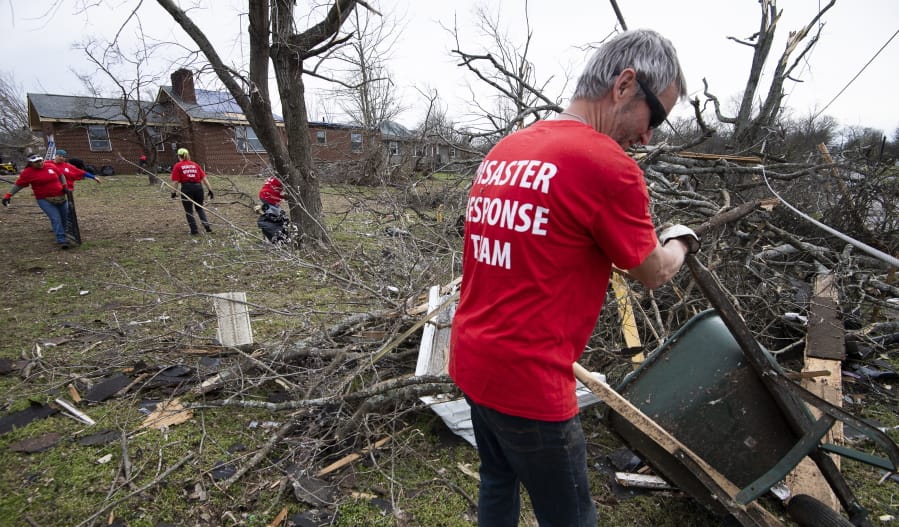 Russ Freeman of Donelson Fellowship church disaster response team works to clean up tornado debris along McGavock Pike on Wednesday in Nashville, Tenn.