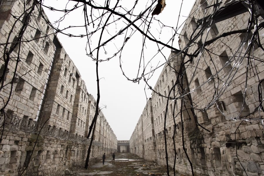Concertina wire and vines line the stone walls of a former cell block Feb. 13 at Sing Sing Correctional Facility in Ossining, N.Y. A not-for-profit group is planning to open the Sing Sing Prison Museum in 2025.