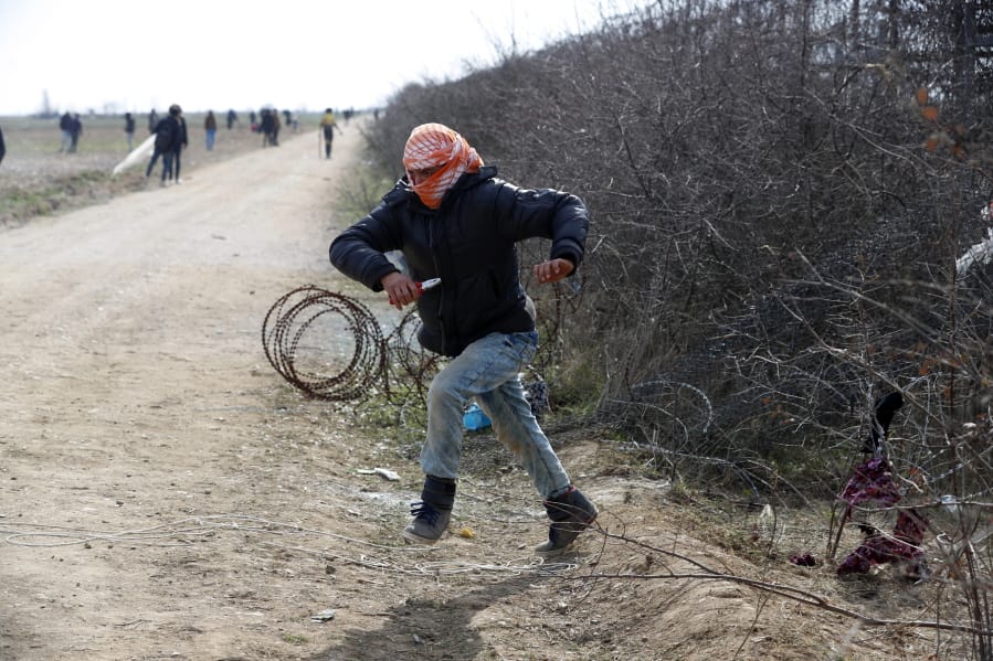 A migrant runs during clashes with the Greek police at the Turkish-Greek border near the Pazarkule border gate in Edirne, Turkey on Monday, March 2, 2020.Thousands of migrants and refugees massed at Turkey&#039;s western frontier, trying to enter Greece by land and sea after Turkey said its borders were open to those hoping to head to Europe.