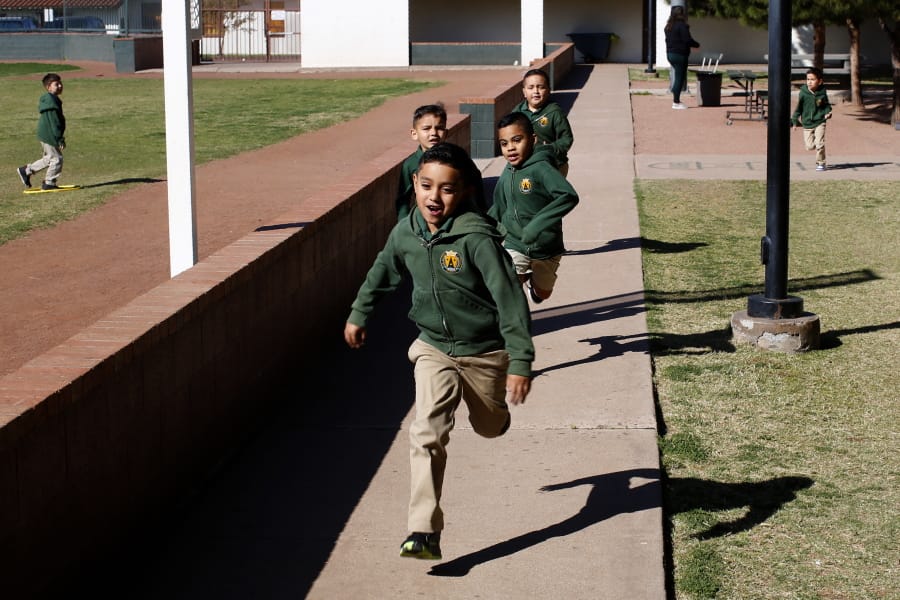 Children run during recess at the St. Agnes Elementary School in Phoenix, Ariz., on March 3, 2020. In 2016, the student body at St. Agnes was two-thirds Hispanic; the figure is now 95%, and virtually every student receives financial aid through state-approved tax credit programs that extend to private schools.