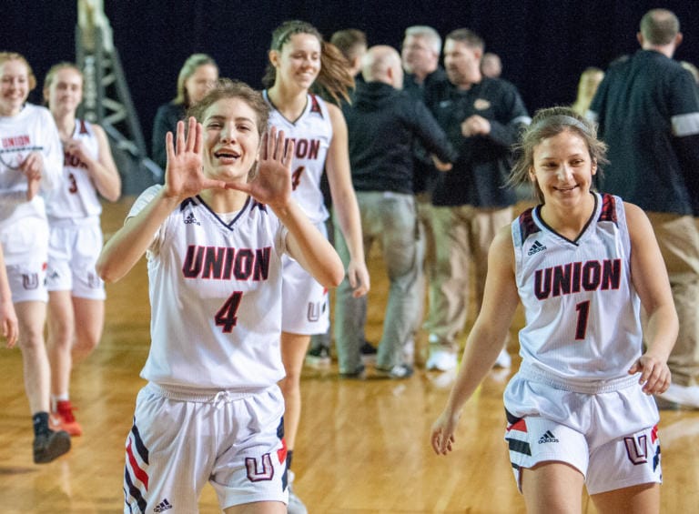 Union's Mason Oberg makes the U sign as she walks off the floor after a 4A State quarterfinal game on Thursday at the Tacoma Dome.
