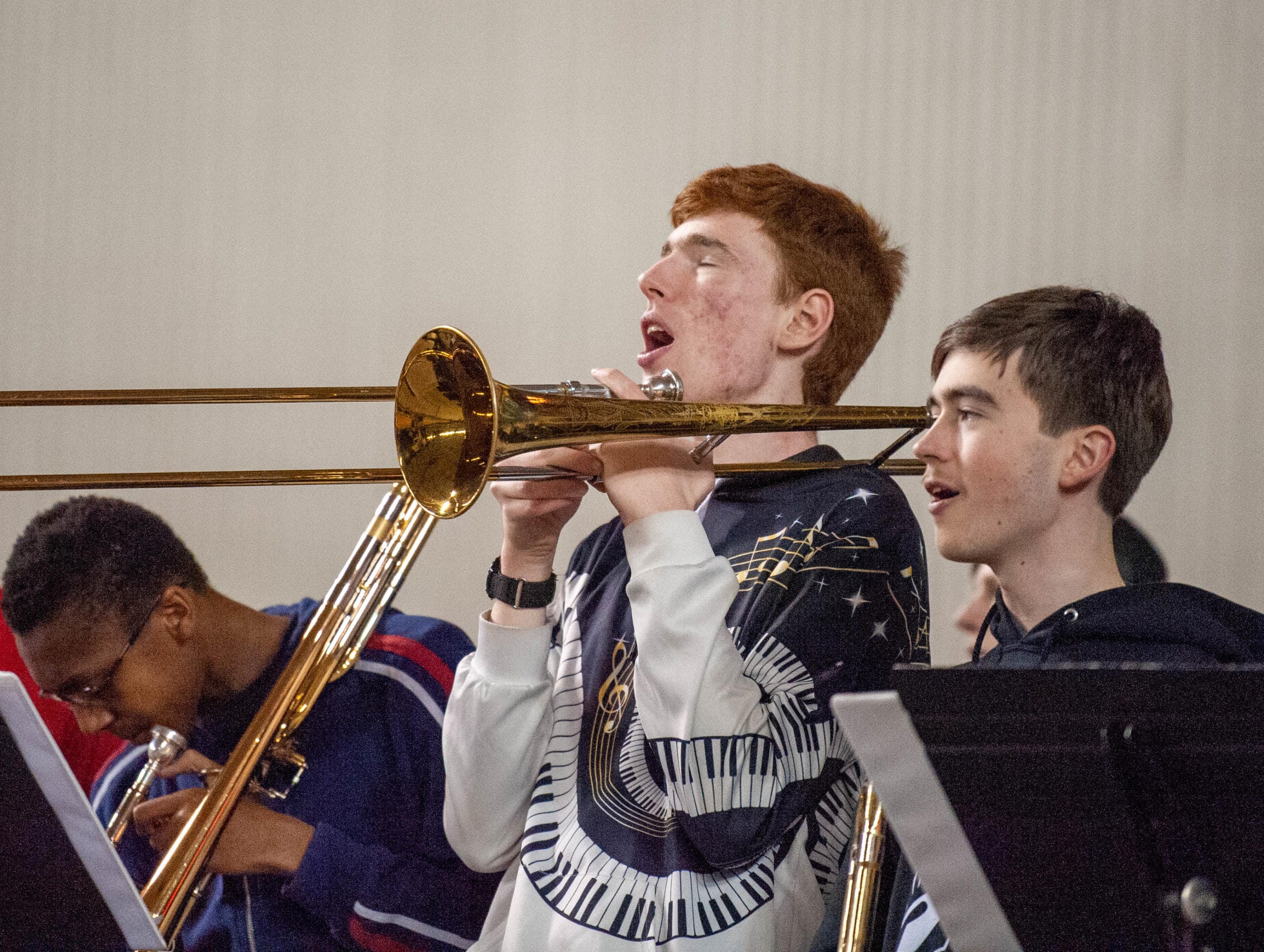 A Union band member sings in between playing the trumpet in a 4A State semifinal Friday at the Tacoma Dome.