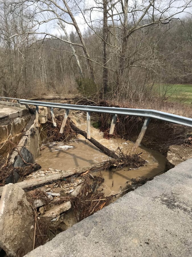 A washed out bridge Friday along Sanes Creek in southeastern Indiana where six people died after two vehicles were swept away by floodwaters.