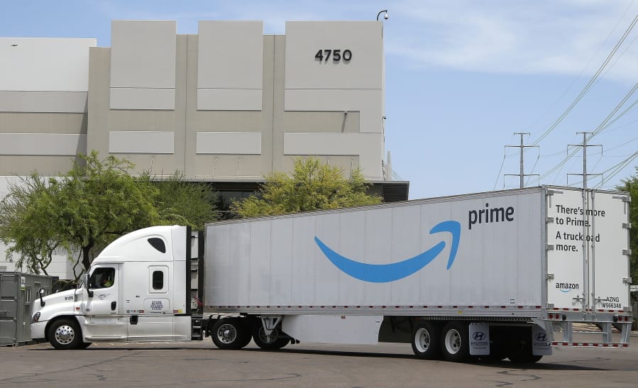 FILE - This July 17, 2019, file photo shows an Amazon shipping truck at a fulfillment center in Phoenix.  Amazon said Tuesday, March 17, 2020,  that it will only accept from suppliers shipments of cleaning equipment, medical supplies and household goods at its warehouses for next three weeks to fill surging demand of those items.(AP Photo/Ross D.