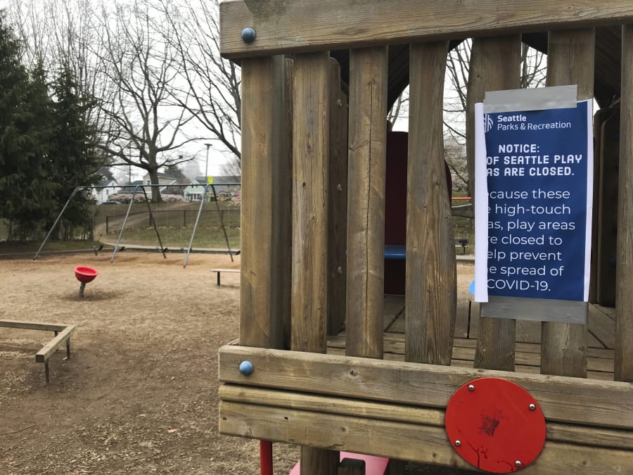 A sign on a play structure in Seattle on Sunday March 22, 2020, informs people the play area is closed. Seattle has shut down all playgrounds in the city to try to stop the spread of the coronavirus.