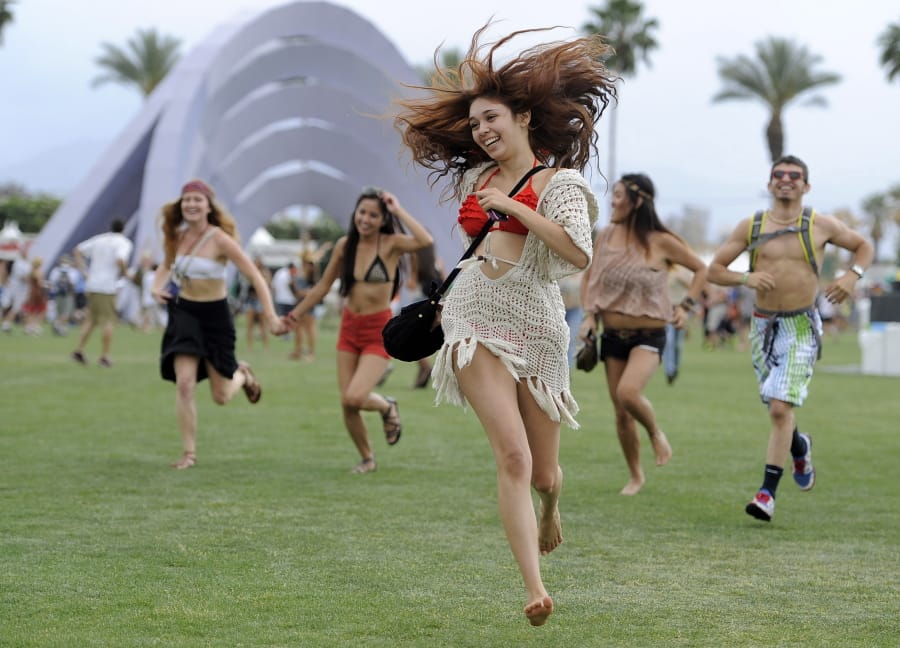Festivalgoers running toward the main stage April 13, 2012, at the 2012 Coachella Valley Music and Arts Festival in Indio, Calif. The Coachella music festival in Southern California has been postponed amid virus concerns.