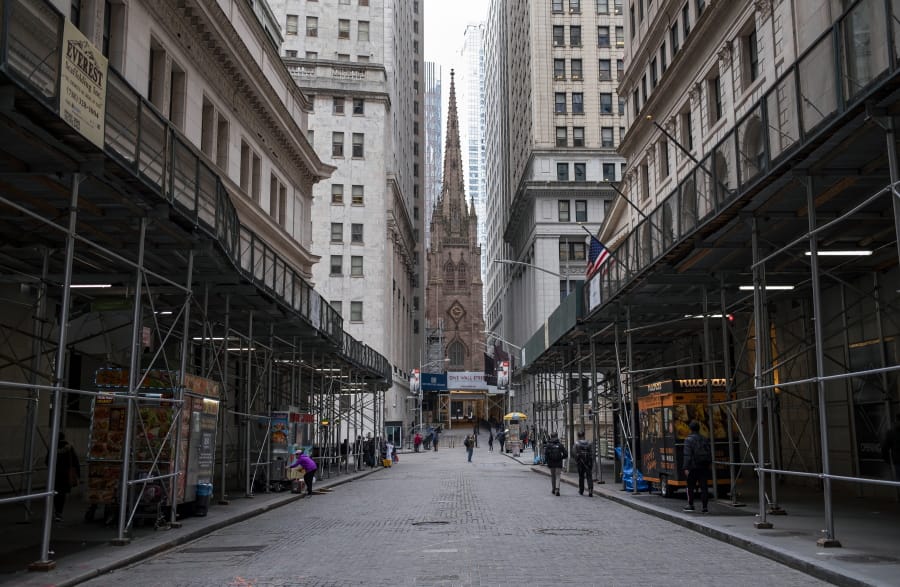 FILE - In this Monday, March 16, 2020, file photo, pedestrian traffic is light along Wall Street in Lower Manhattan in New York. The banking system is not as risk of failing as banks have plenty of capital on hand to handle this crisis due to the new coronavirus, economists say.