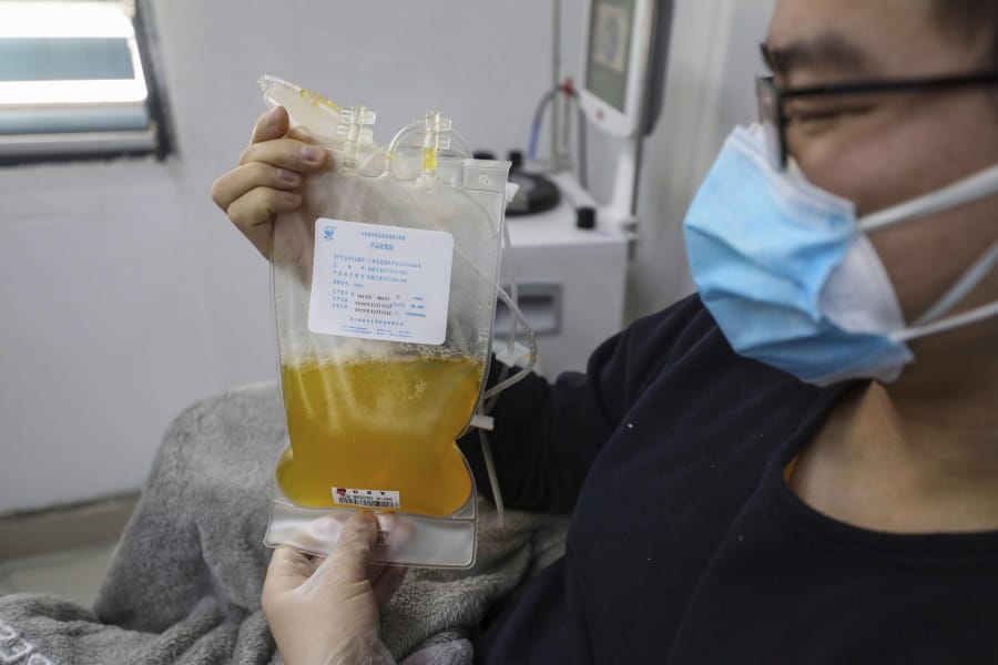 FILE - In this Feb. 18, 2020, file photo, Dr. Zhou Min, a recovered COVID-19 patient who has passed his 14-day quarantine, donates plasma in the city&#039;s blood center in Wuhan in central China&#039;s Hubei province. Plasma from recovered COVID-19 patients contains antibodies that may help reduce the viral load in patients that are fighting the disease.