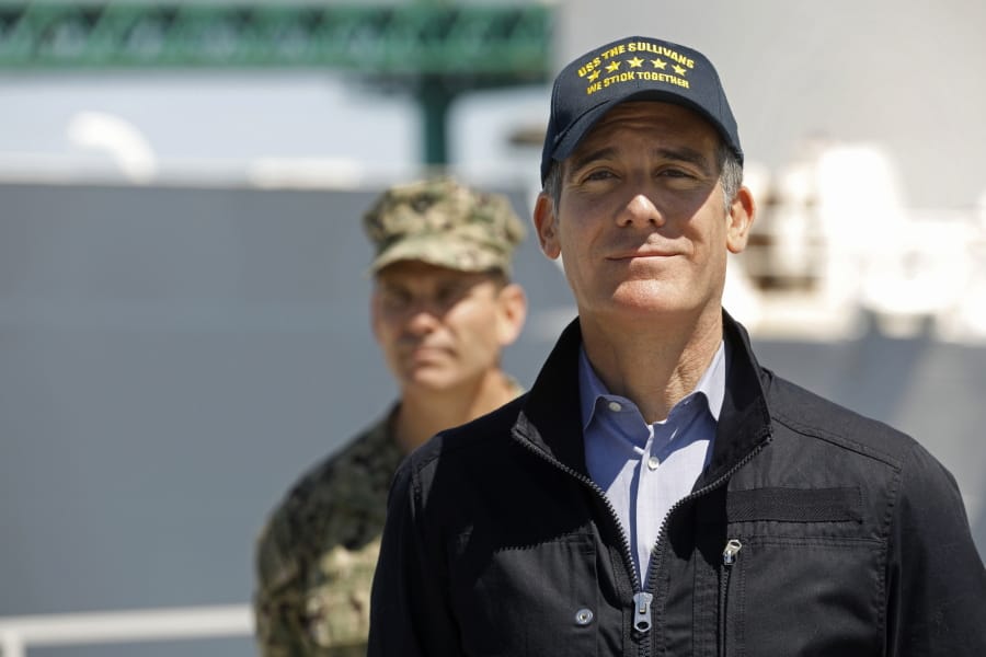 Los Angeles Mayor Eric Garcetti listens as California Governor Gavin Newsom speaks in front of the hospital ship US Naval Ship Mercy that arrived into the Port of Los Angeles on Friday, March 27, 2020, to provide relief for Southland hospitals overwhelmed by the coronavirus pandemic. Admiral John Gumbleton, U.S. Navy stands behind Mayor Garcetti.