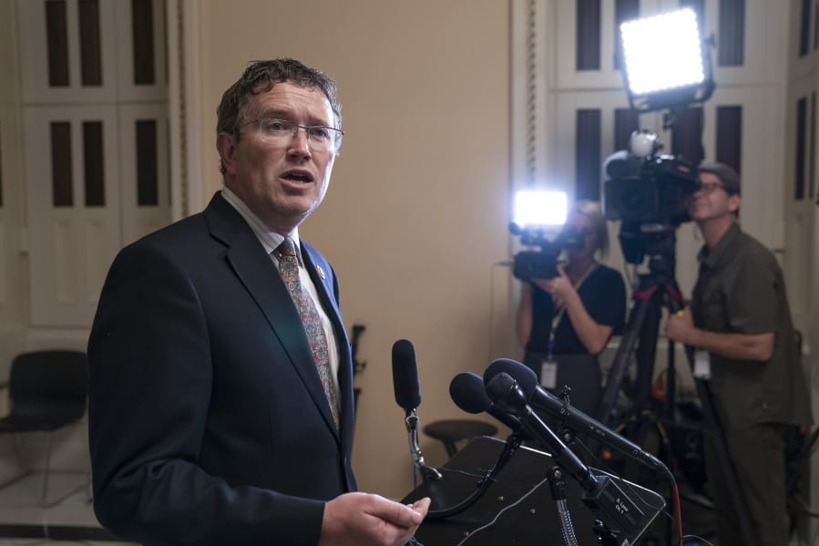 In this Tuesday, May 28, 2019 file photo, Rep. Thomas Massie, R-Ky., speaks to reporters at the Capitol after he blocked a unanimous consent vote on a long-awaited hurricane disaster aid bill in the chamber. House leaders&#039; plan for swift action on a $2.2 trillion package to ease the coronavirus pandemic&#039;s devastating toll on the U.S. economy and health care system ran into complications Friday, March 27, 2020, as the maverick conservative threatened to delay passage until most lawmakers return to Washington for a vote. Party leaders had hoped to pass the measure by voice vote without lawmakers having to take the risk of traveling to Washington. (AP Photo/J.