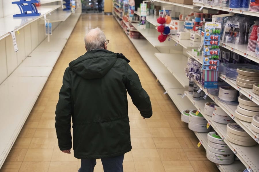 A shopper looks for toilet paper Thursday at a supermarket in Rhode Island. Federal law enforcement warns that scam artists are preying on older people&#039;s fears, peddling fake tests for the coronavirus to Medicare recipients.