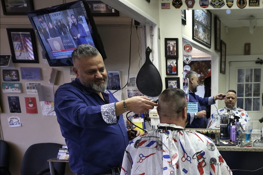 Barber Sami Matta, left, gives a haircut to Steve Perosino, of Dedham, Mass., right, at Chris &amp; Sam&#039;s Barbershop, in Norwood, Mass., Monday, March 23, 2020. The Barbershop is to close by noon Tuesday, March 24, in keeping with Mass. Gov. Charlie Baker&#039;s order that all non-essential businesses close at noon Tuesday and remain closed through Tuesday, April 7, out of concern about the spread of the coronavirus. For most people, the new coronavirus causes only mild or moderate symptoms, such as fever and cough. For some, especially older adults and people with existing health problems, it can cause more severe illness, including pneumonia. The vast majority of people recover from the new virus.