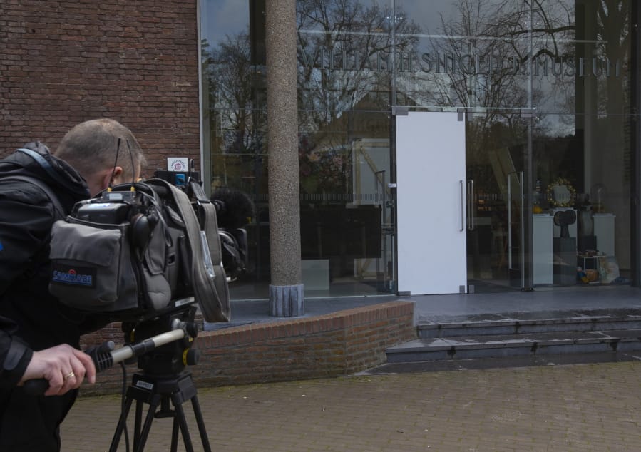 A cameraman films the glass door which was smashed during a break-in at the Singer Museum in Laren, Netherlands, Monday March 30, 2020. Police are investigating a break-in at a Dutch art museum that is currently closed because of restrictions aimed at slowing the spread of the coronavirus, the museum and police said Monday.