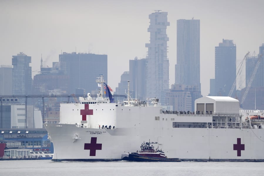 The Navy hospital ship USNS Comfort passes lower Manhattan on its way to docking in New York, Monday, March 30, 2020. The ship has 1,000 beds and 12 operating rooms that could be up and running within 24 hours of its arrival on Monday morning. It&#039;s expected to bolster a besieged health care system by treating non-coronavirus patients while hospitals treat people with COVID-19.