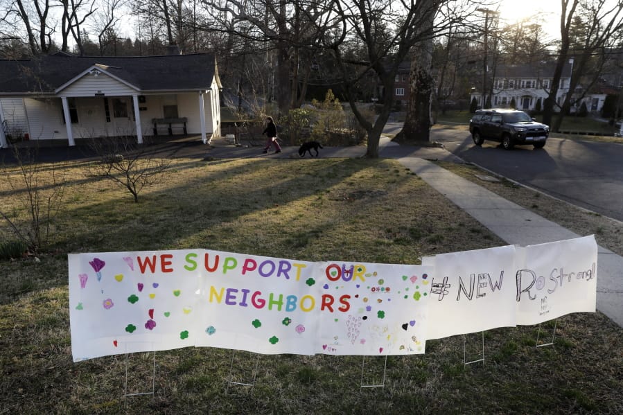 A sign showing support for residents is displayed on a lawn in New Rochelle, N.Y., Wednesday, March 11, 2020. State officials are shuttering several schools and houses of worship for two weeks in the New York City suburb and sending in the National Guard to help with what appears to be the nation&#039;s biggest cluster of coronavirus cases, Gov. Andrew Cuomo said Tuesday.