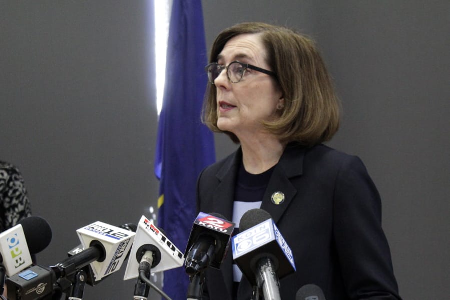 Gov. Kate Brown speaks at a news conference to announce a four-week ban on eat-in dining at bars and restaurants throughout the state Monday, March 16, 2020, in Portland, Ore. Restaurants can still offer take-out and delivery. The order is intended to slow the spread of the new coronavirus in Oregon and mirrors similar bans elsewhere, including Washington state.