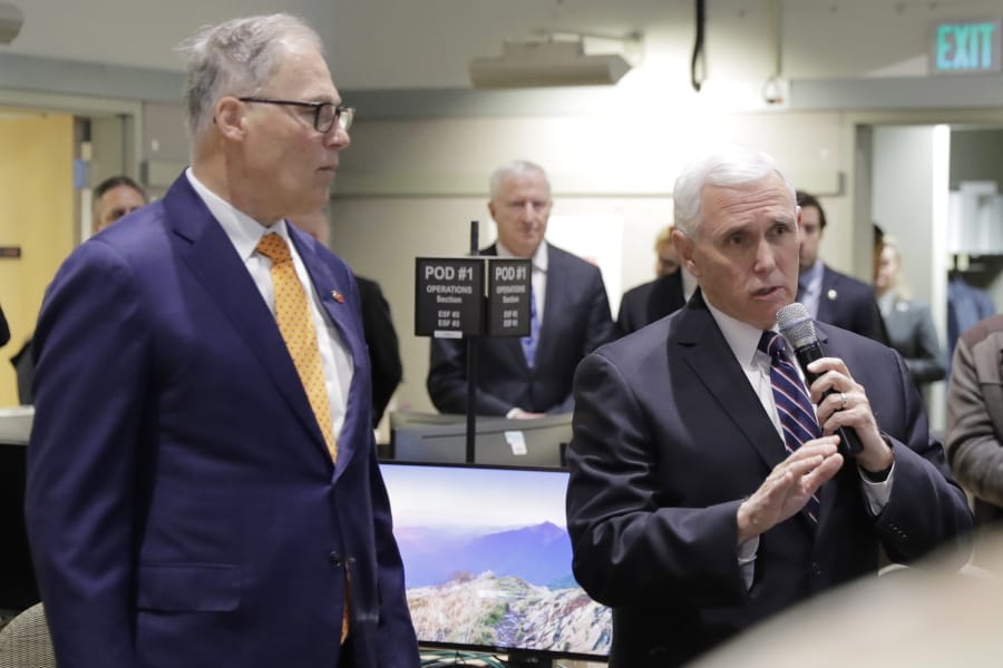 Vice President Mike Pence, right, speaks with Gov. Jay Inslee at the Washington State Emergency Operations Center, Thursday, March 5, 2020 at Camp Murray in Washington state. Pence was visiting to discuss Washington state&#039;s efforts to fight the COVID-19 coronavirus. (AP Photo/Ted S.
