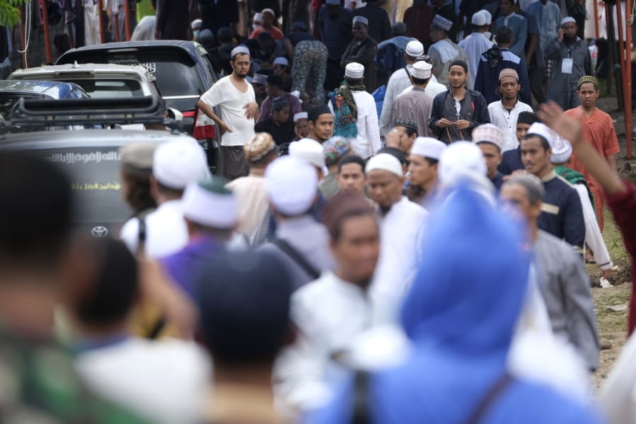 Pilgrims make their way through the crowd on a field where a mass congregation is supposed to be held in Gowa, South Sulawesi, Indonesia, Thursday, March 19, 2020. Indonesia halted the congregation of thousands of Muslim pilgrims and began quarantining and checking their health Thursday to prevent the spread of the new coronavirus. The vast majority of people recover from the new coronavirus. According to the World Health Organization, most people recover in about two to six weeks, depending on the severity of the illness.