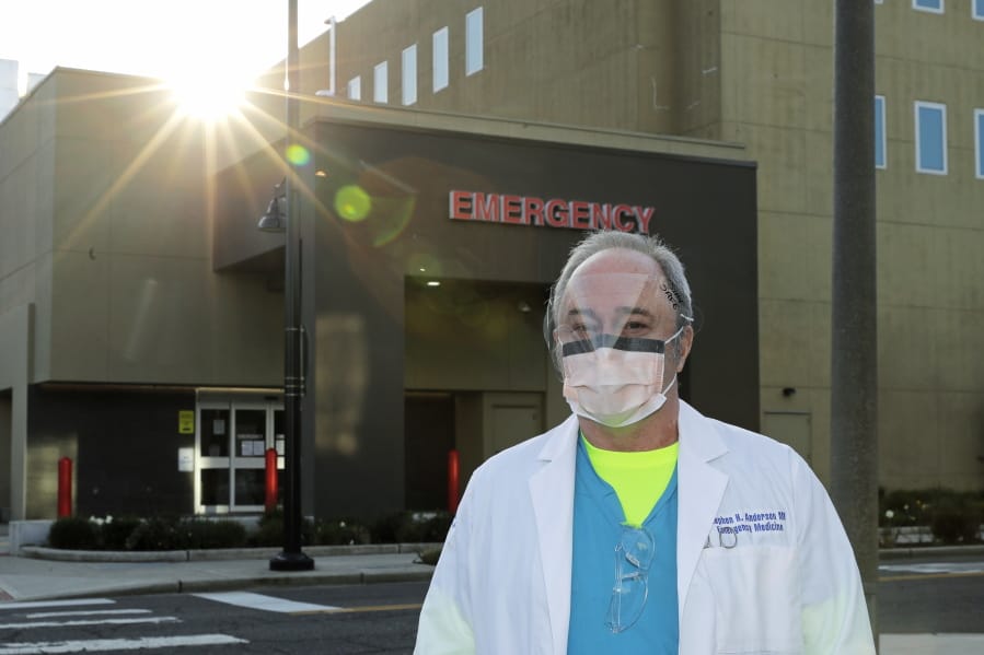Dr. Stephen Anderson, a physician who works in the Emergency Department at the MultiCare Auburn Medical Center in Auburn, wears a mask and face shield before starting his shift Tuesday. (Ted S.