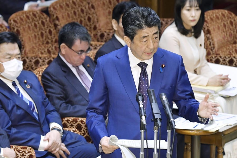 Japan&#039;s Prime Minister Shinzo Abe speaks at a parliamentary session in Tokyo Monday, March 23, 2020. Abe said a postponement of Tokyo Olympics would be unavoidable if the games cannot be held in a complete way because of the coronavirus pandemic.
