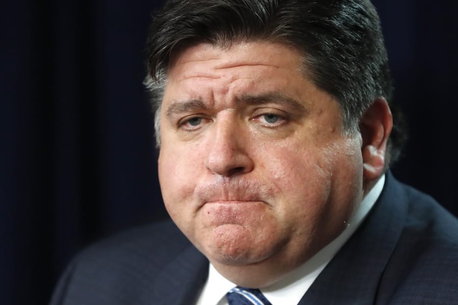 In this March 19, 2020 photo, Illinois Gov. J.B. Pritzker listens to a question during a news conference in Chicago. Amid an unprecedented public health crisis, the nation&#039;s governors are trying to get what they need from the federal government - and fast. But often that means navigating the disorienting politics of dealing with President Donald Trump.