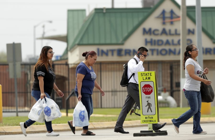 Pedestrians cross from Mexico to Texas at the McAllen Hidalgo International Bridge, Friday, March 20, 2020, in Hidalgo, Texas. President Donald Trump announced Friday the U.S.-Mexico border will be closed to nonessential travel to further help stem the spread of the coronavirus.