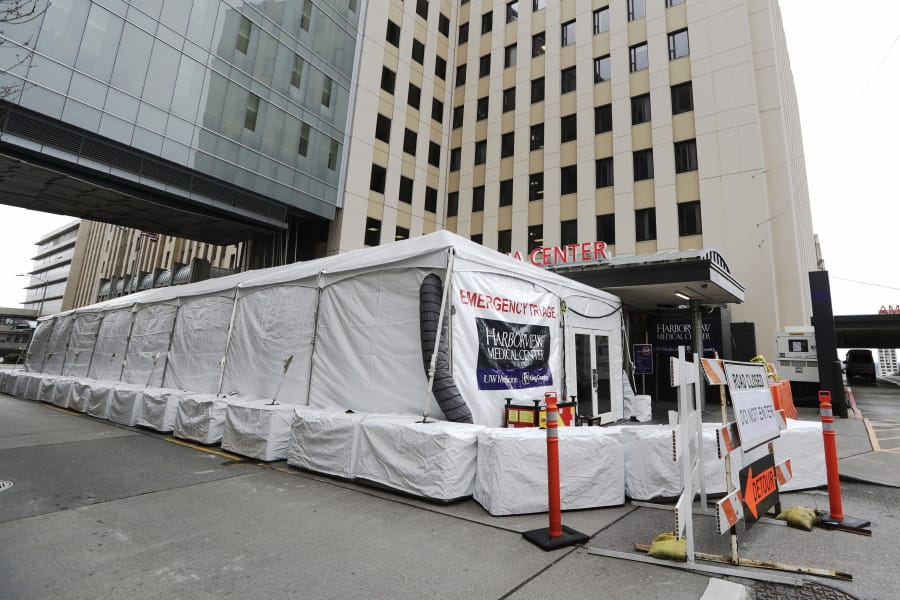 A new tent stands outside the emergency entrance of Harborview Medical Center Saturday, March 28, 2020, in Seattle. Harborview and University of Washington Medicine are preparing a &quot;surge plan&quot; that will enable its hospitals to better respond to the coronavirus outbreak. Under the plan, ambulatory patients with respiratory illness symptoms will be separated from other patients when they arrive at hospitals&#039; emergency departments and be directed to a new treatment area in a tent outside of the emergency department.