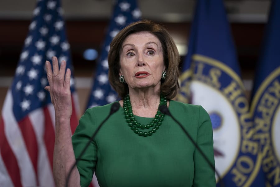 Speaker of the House Nancy Pelosi, D-Calif., updates reporters as lawmakers continue work on a coronavirus aid package, on Capitol Hill in Washington, Thursday, March 12, 2020. (AP Photo/J.