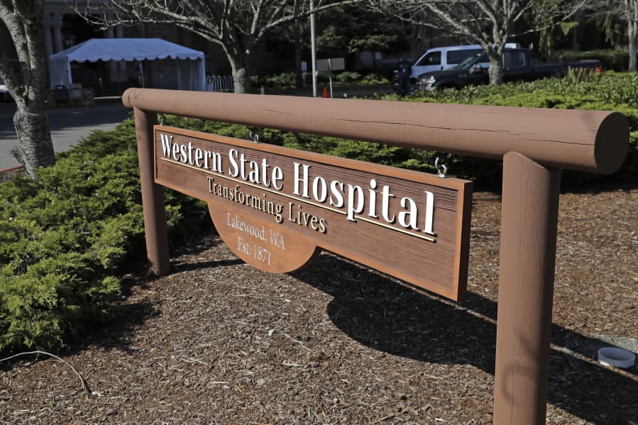A sign near an entrance to Western State Hospital is shown Thursday, March 19, 2020, in Lakewood, Wash. A patient and a worker at the facility, Washington state&#039;s largest psychiatric hospital, have tested positive for the new coronavirus. The tent shown behind the sign will eventually be used for screening employees for symptoms of the virus as they arrive for work. (AP Photo/Ted S.