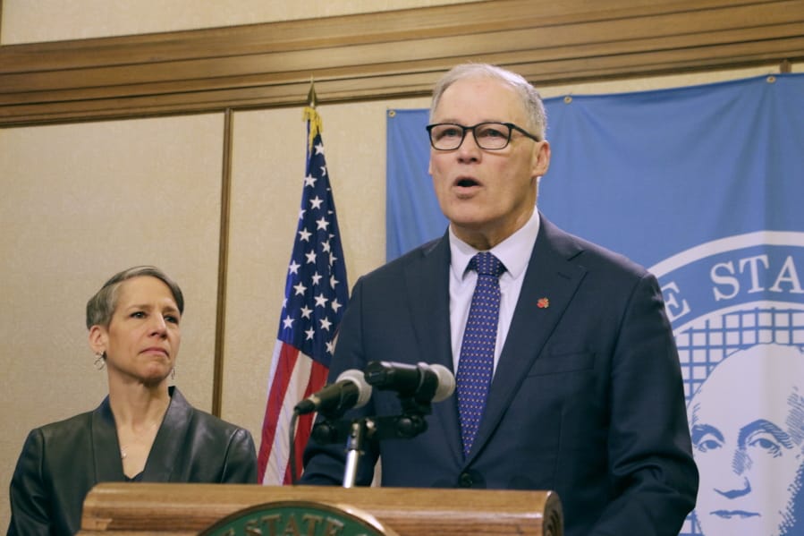 Washington Gov. Jay Inslee, right, talks to the media about the latest actions the state is taking to respond to the coronavirus outbreak, as Employment Security Department Commissioner Suzi LeVine looks on, Tuesday, March 10, 2020, in Olympia, Wash. Inslee announced a list of requirements for long-term care facilities and new rules related to the unemployment insurance program for workers impacted by COVID-19.