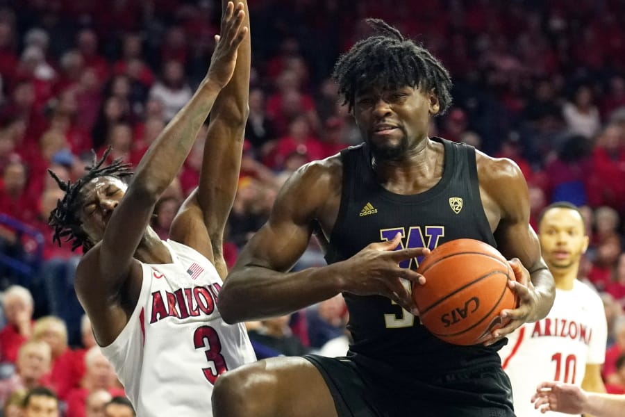 Washington forward Isaiah Stewart drives on Arizona guard Dylan Smith (3) during the first half of an NCAA college basketball game Saturday, March 7, 2020, in Tucson, Ariz. Smith broke his nose on the play.