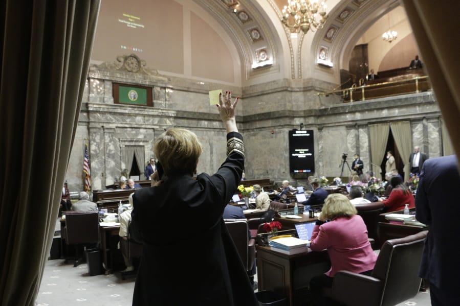 Democratic Sen. Lisa Wellman raises her hand during a vote in the Washington Senate, Thursday, March 12, 2020 in Olympia, Wash. Lawmakers were finishing up their work amid concerns of the state&#039;s COVID-19 outbreak. For most people, the new coronavirus causes only mild or moderate symptoms. For some it can cause more severe illness.