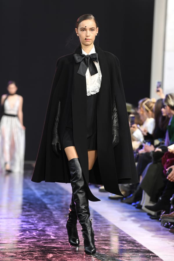 A model in a cape walks the runway during the Elie Saab show as part of the Paris Fashion Week Womenswear Fall/Winter 2020/2021 on Feb. 29 in Paris, France.