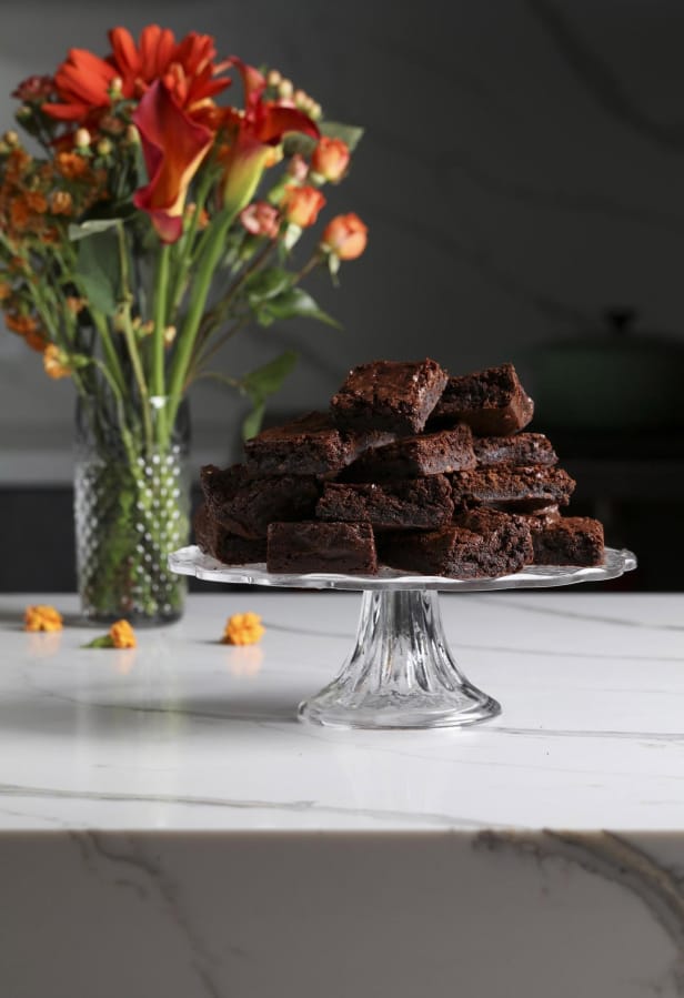 Brownies made with green banana flour are studded with cacao nibs for more chocolate flavor and for texture.