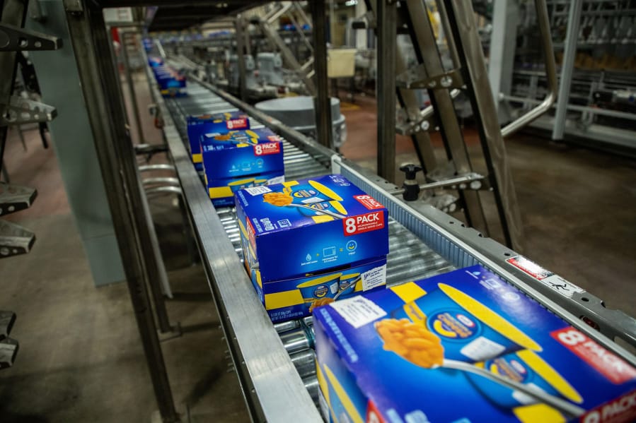Packages of Easy Mac Macaroni &amp; Cheese Cups move along the production line on March 27, 2020, at the Kraft Heinz manufacturing plant in Champaign, Ill.
